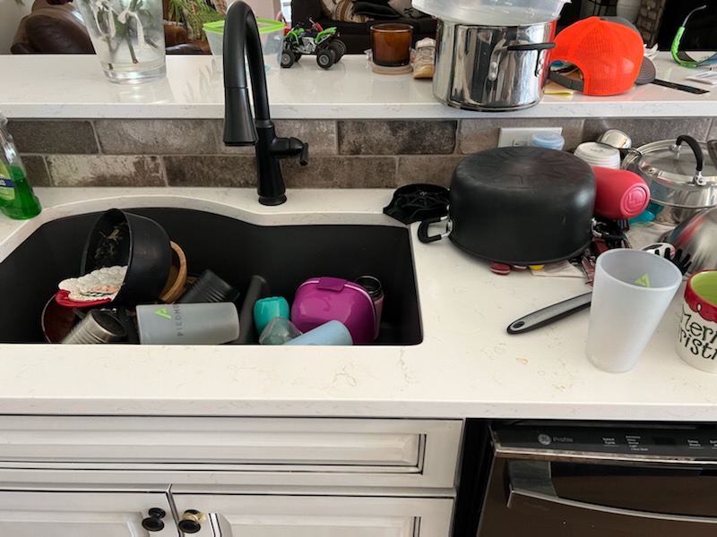 kitchen sink with dirty dishes piled up